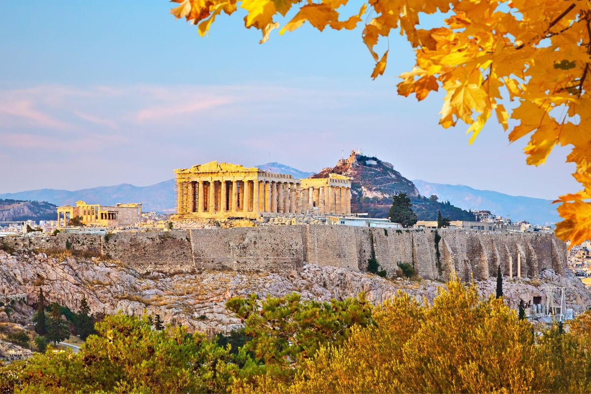 View of the Acropolis in Athens with autumn leaves in the foreground.